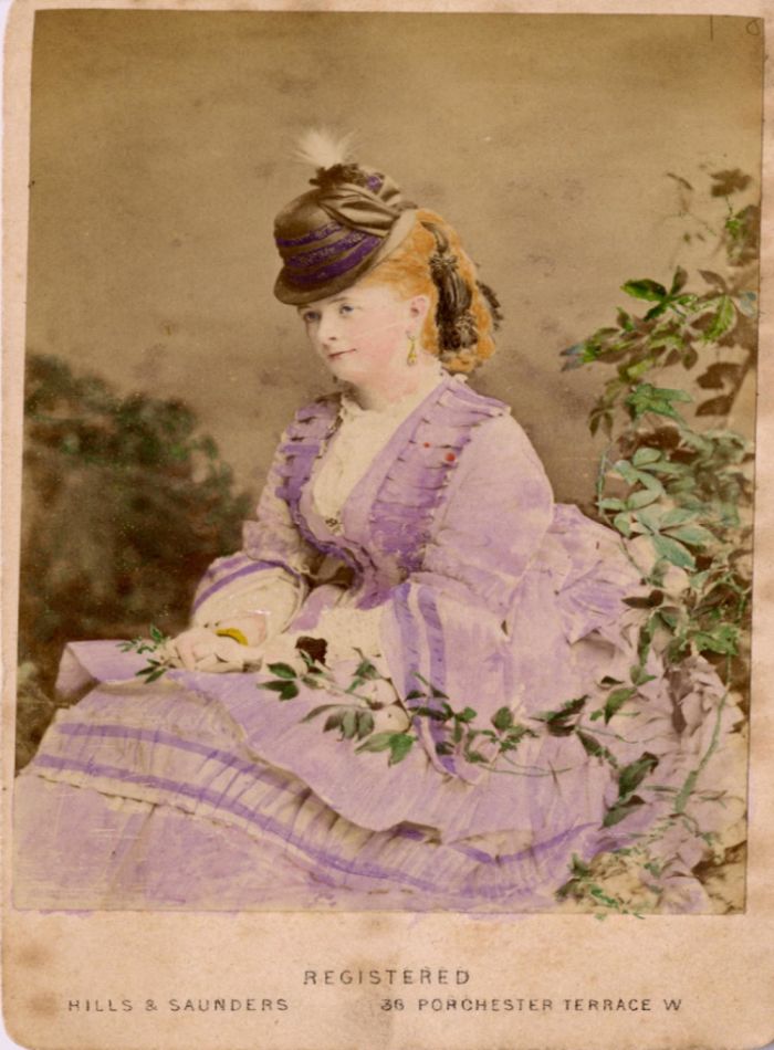 Hand-tinted photograph of a woman, taken by Hills & Saunders of 36 Porchester Terrace W, London, England.