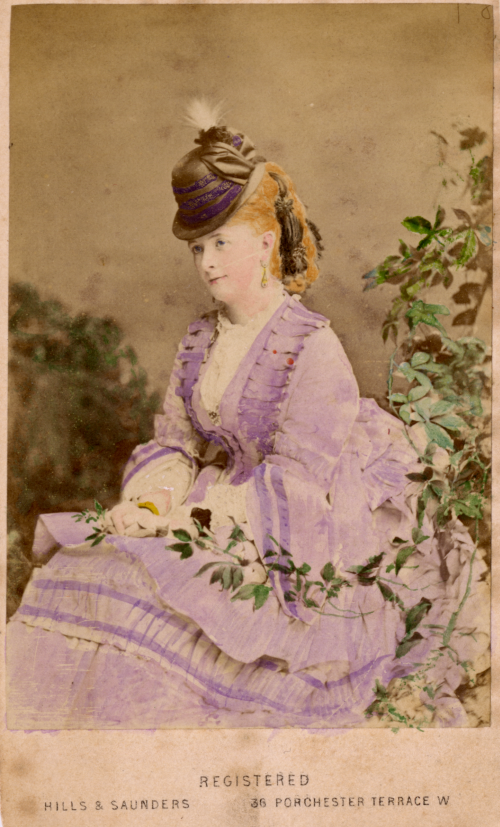 Hand-tinted photograph of a seated woman.