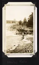 Man standing at base of a waterfall.