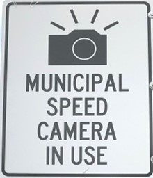 Sign reads "Municipal speed camera in use".